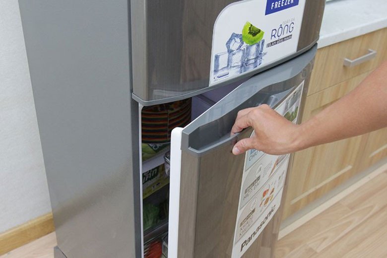 Hình ảnh người dùng đang thao tác với tủ lạnh, minh họa các mẹo sử dụng để tủ lạnh tiết kiệm điện năng