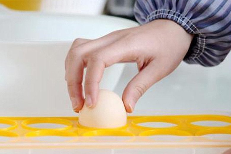 Hộp đựng trứng chuyên dụng trong tủ lạnh với các quả trứng được đặt đúng chiều, đầu to hướng lên trên.
